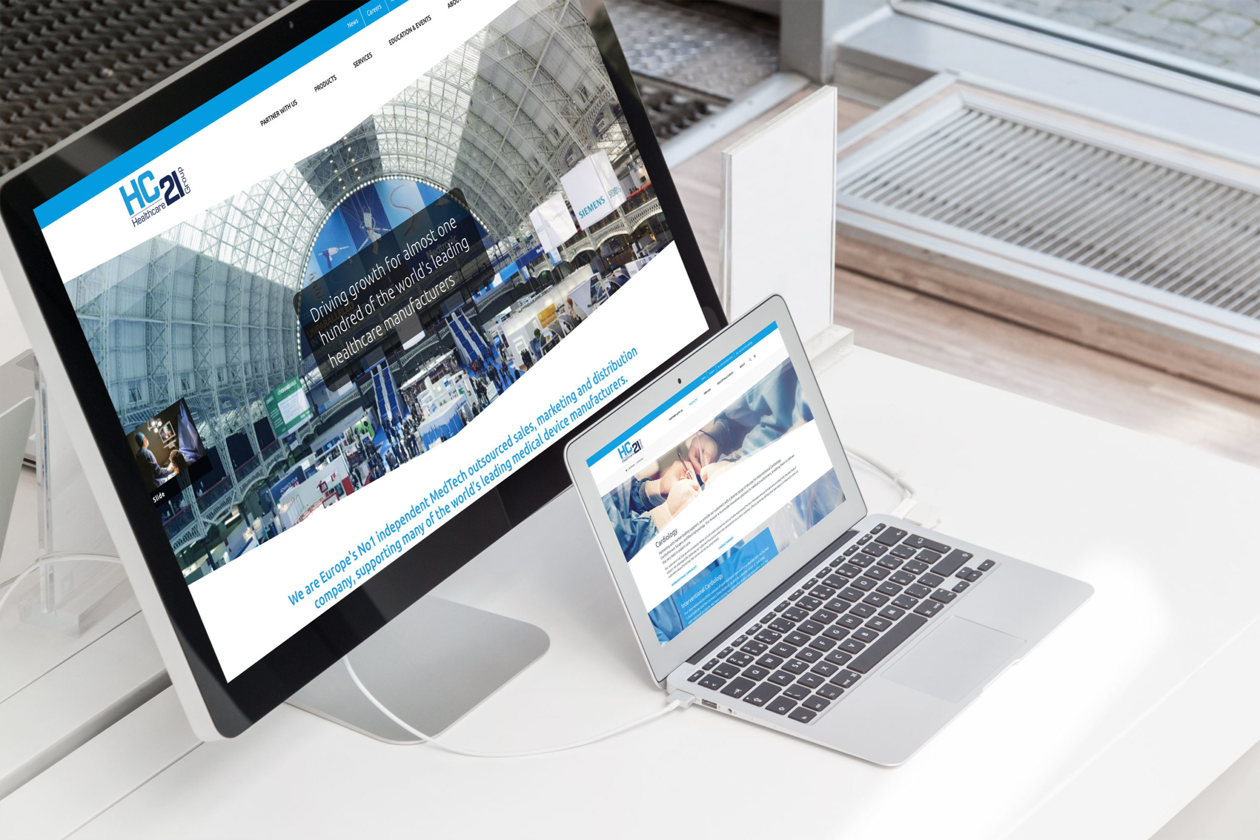 Responsive website design for HC21, Europe’s leading independent MedTech sales and marketing provider, displayed on desktop and laptop screens.