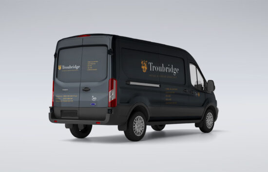 Vehicle livery design by Montpellier Creative for Troubridge, featuring elegant branding and gold typography on a dark van for the antique and interior consultancy firm.